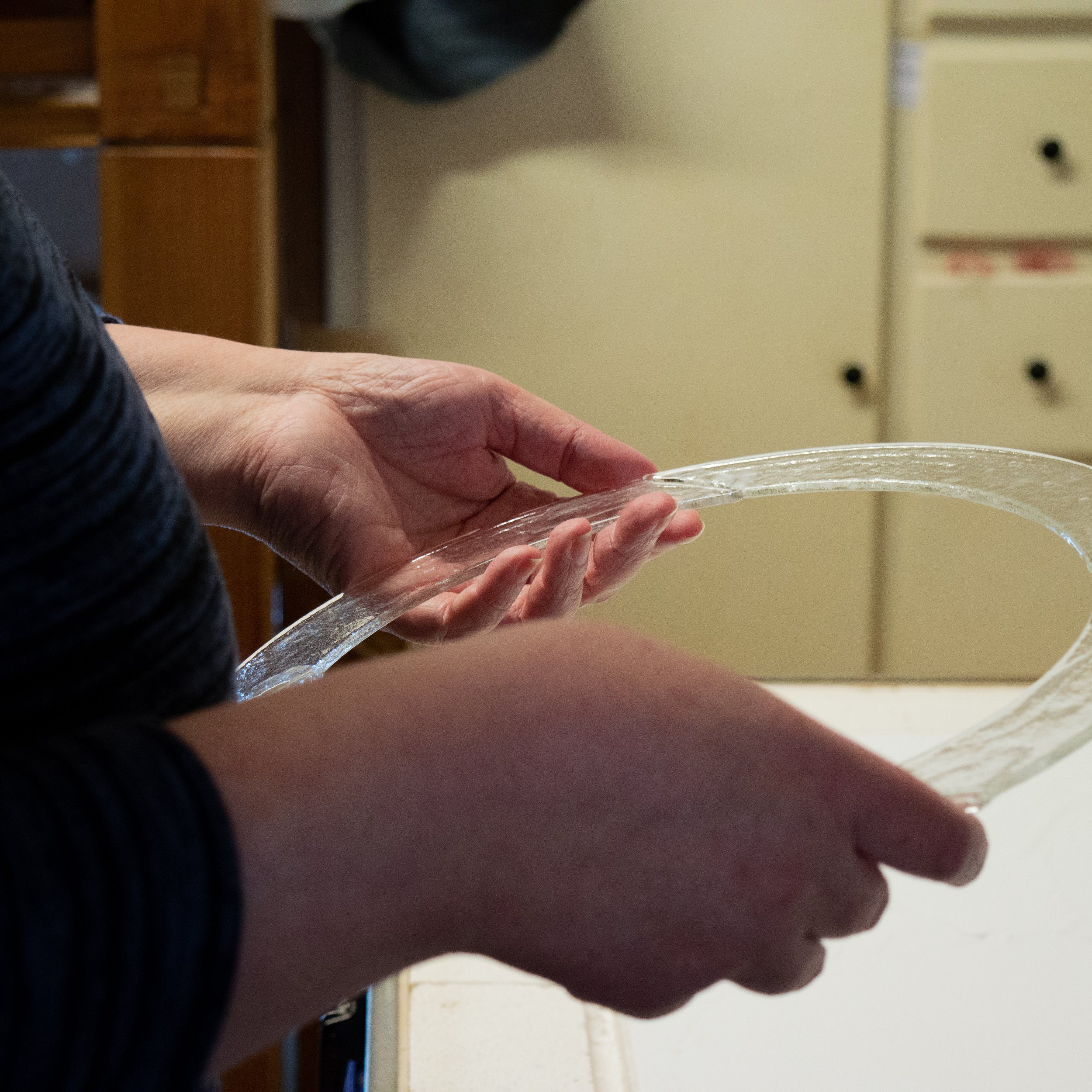 hands holding cut glass circle